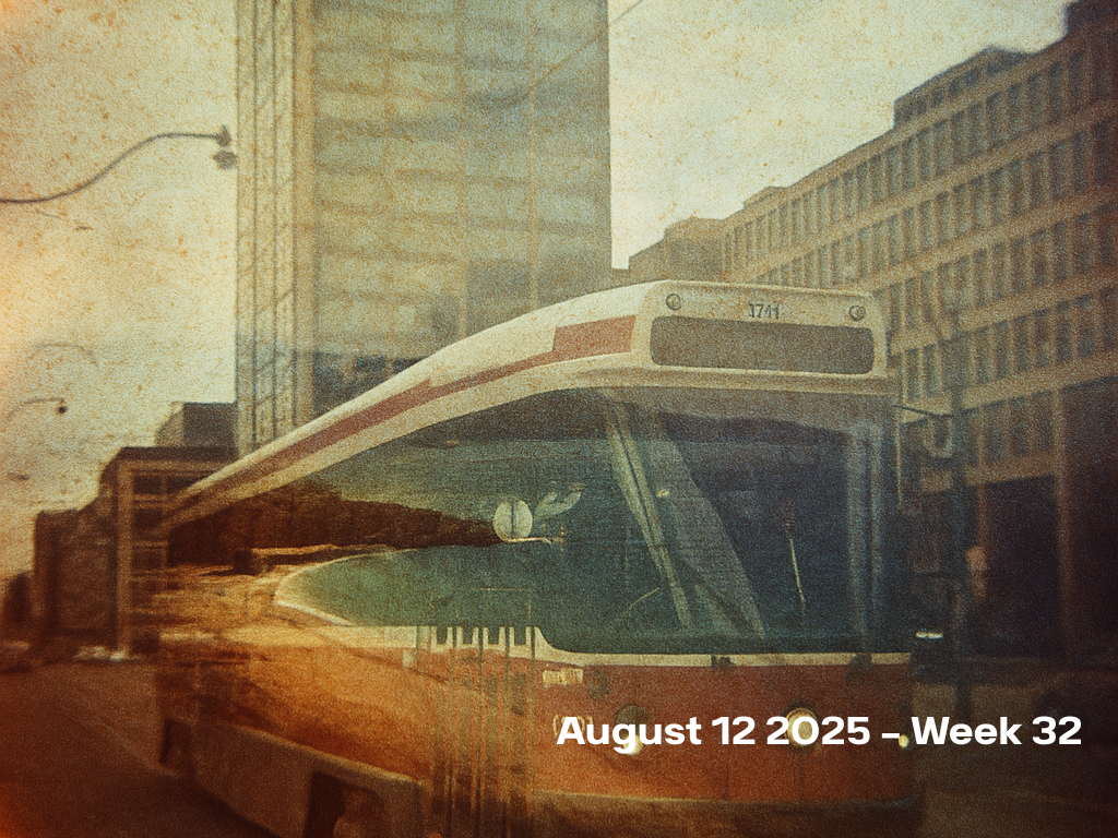 Vintage film photograph of a white and red TTC streetcar stopped in front of Toronto’s iconic bell building